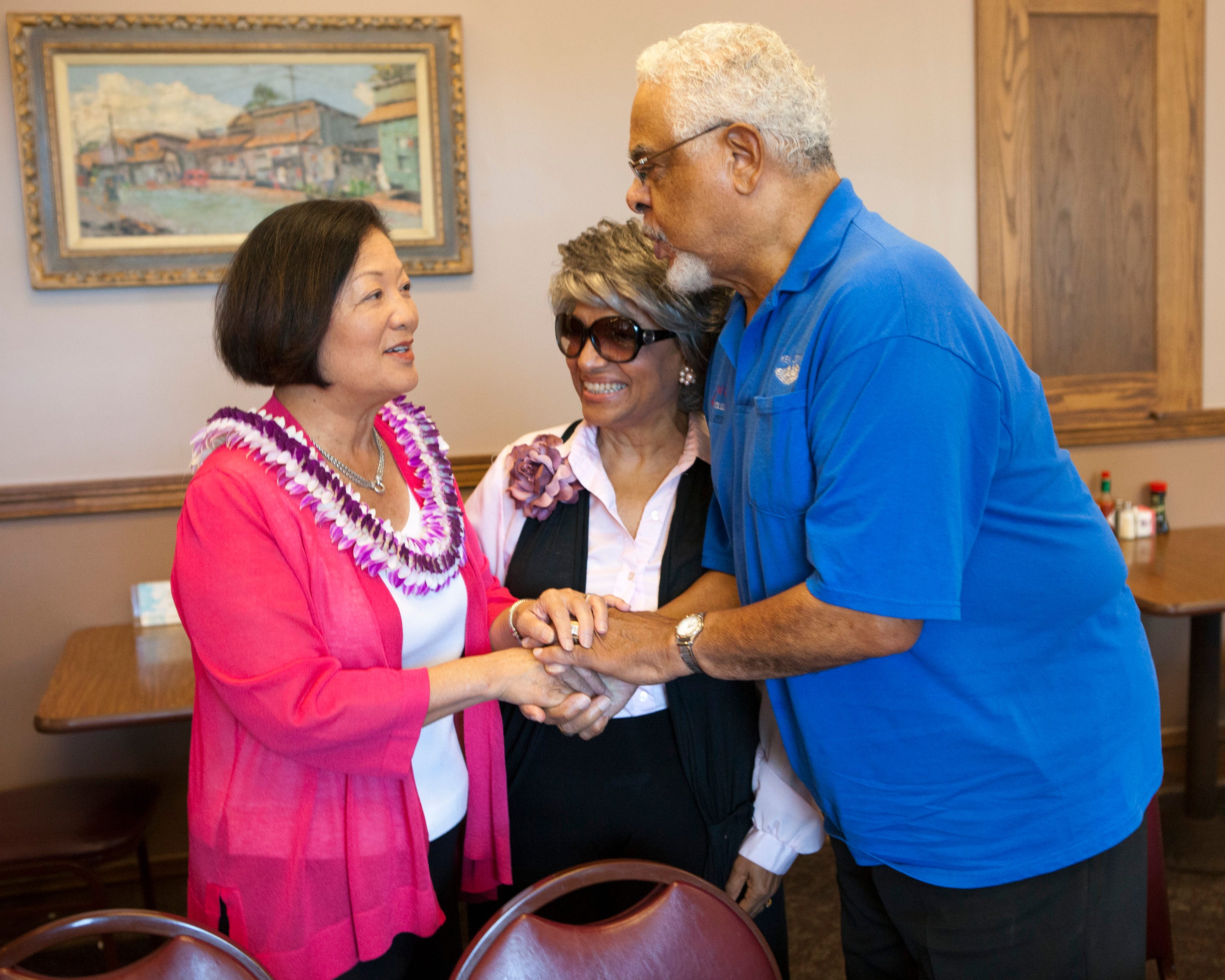 Democratic U.S. Senate candidate Maize Hirono, left, greets Marsha Joyner, center, and Korean War veteran Kenneth Joyner, 81, at the Like Like Drive Inn restaurant Nov. 6, 2012, in Honolulu.