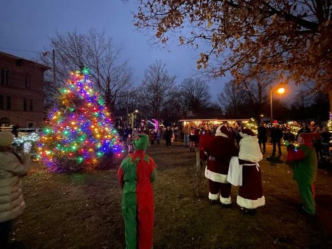 Santa and Mrs. Clause light the Christmas Tree in G Carl Fast Park in Jonesville Friday night to kick off festivities after arriving on a horse-drawn carriage.
