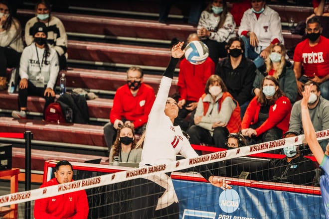 Texas Tech's Kenna Sauer (11) attempts to spike the ball against Florida Gulf Coast during a first-round NCAA Tournament match at UW Fieldhouse in Madison, Wisconsin. Sauer finished with 18 kills and 17 digs, but the Red Raiders dropped a five-setter to the Eagles.
