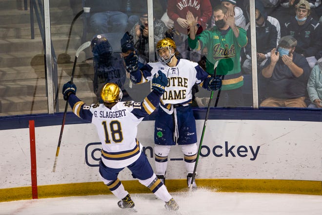 Notre Dame's Ryder Rolston (12) celebrates with Graham Slaggert (18) during the Notre Dame vs. Ohio State NCAA hockey game Friday, Dec. 3, 2021 at the Compton Family Ice Arena in South Bend. 