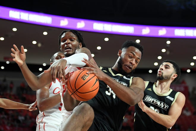 Bryant forward Hall Elisias (34) grabs a rebound against Houston center Josh Carlton during a game on Dec. 3. Wednesday's game against Eastern Kentucky has been called off due to coronavirus issues.