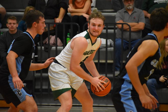 Monrovia senior Mason McClung plays keep-away from a Cascade defender as he waits for an opening on offense during their game on Dec. 3, 2021