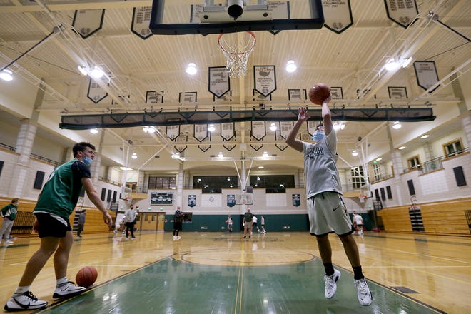 Marsheild High sophomore James Molloy goes up for a shot during a shooting drill during winter sports tryouts at Marshfield High School on Thursday, Dec. 2, 2021.