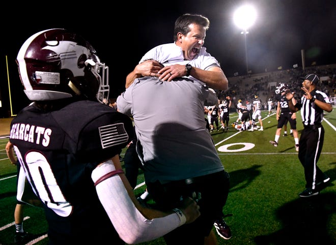 Hawley High School head coach Mitch Ables is lifted into the air by his brother Kris after Hawley defeated Cisco during Friday's Regional championship football game in Abilene