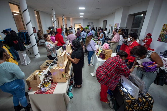 Customers shop during the JXN Flea Local Artisan Holiday Market and Toy Drive at the Heritage Building, as a part of the Capital City Lights event in downtown Jackson last year.