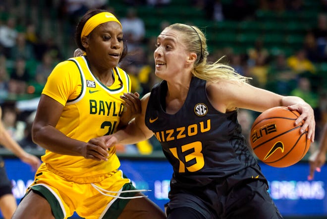 Missouri guard Haley Troup (13) draws contact from Baylor guard Ja'Mee Asberry (21) during a game Saturday in Waco, Texas.
