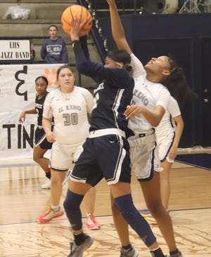 Shawnee's Amaya Martinez snatches the ball in attempt to make a move against the El Reno defense Friday night.