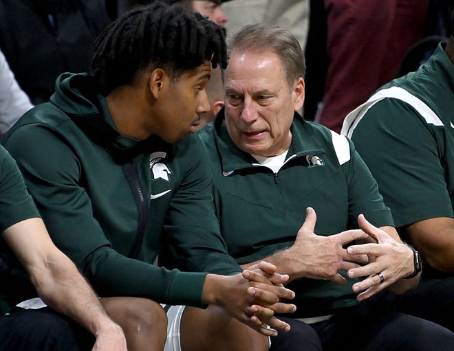 Michigan State Spartans head coach Tom Izzo talks with Michigan State Spartans guard AJ Hoggard (11) on the bench in the second half Dec. 4, 2021 at Breslin Center in East Lansing.