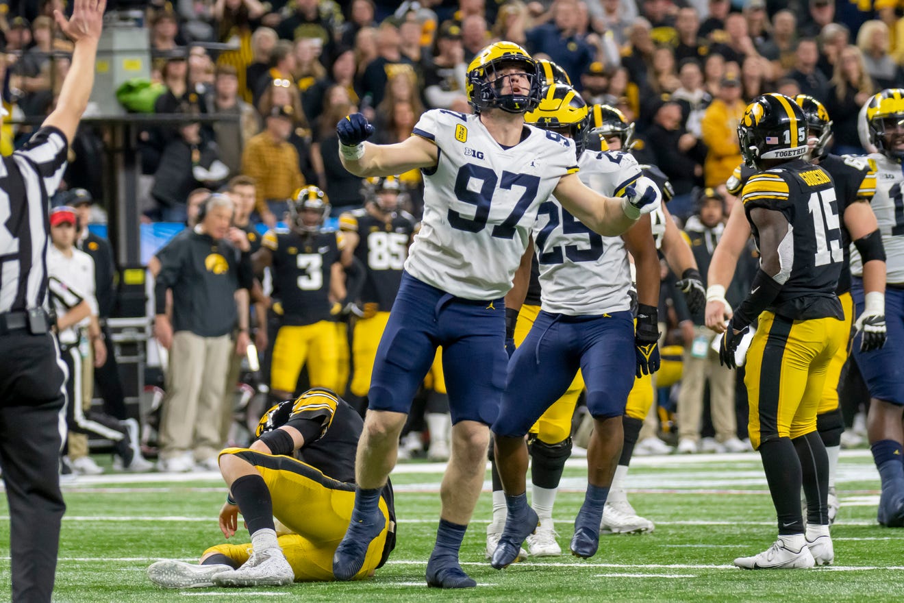 Michigan defensive end Aidan Hutchinson celebrates after sacking Iowa quarterback Spencer Petras in the Big Ten Championship Game.