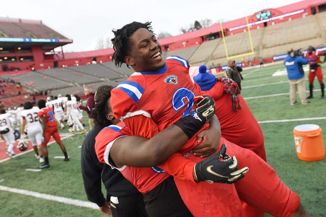 Ahmad Nalls, #2, of East Orange Campus, who made the winning touchdown against Clifton in the third overtime, is celebrated by his teammate in the North Group 5 Regional Championship Football Game at Rutgers SHI Stadium in Piscataway on 12/05/21.