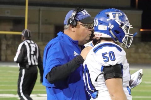 Falls City head coach Mark Kirchhoff, a native of Mason and graduate of Angelo State University, coaches one of his athletes during a high school football game.