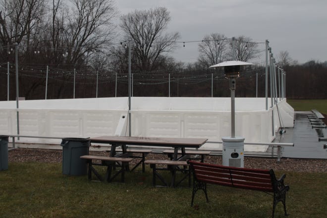 Picnic tables, bleachers, benches, swings and outdoor heaters surround  the new skating rink in the Village of Caldwell