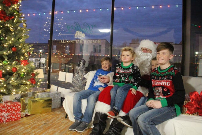 From left, Grayson, Braydon, Hudson and Landon Carter pose for a photo with Santa Claus during the Hometown Christmas event on Saturday, Dec. 4, 2021, at The Gallery by Board and Batten in Dallas Center. Santa will return from 4-8 p.m. on Wednesday, Dec. 7 at Board and Batten.