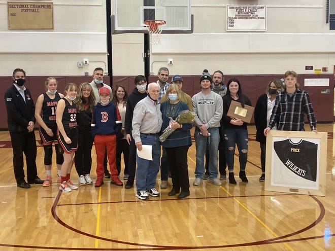 The family of Tom Price gathers on the court at Wayland during the Hall of Fame Showcase that was dedicated to the late Jasper-Troupsburg head coach.