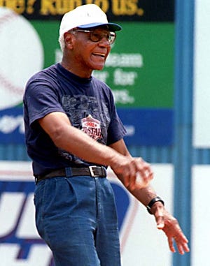 John "Buck" O'Neill, the first basemen from the Kansas City Monarchs of the Old Negro Leagues who was a focal point of Ken Burns' "Baseball" documentary, throws out a ceremonial first pitch at McCormick Field on July 7, 1996.
