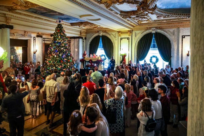 A crowd gathers on Dec. 5, 2021, to witness the lighting of the Christmas tree in the Grand Hall at the Flagler Museum.
