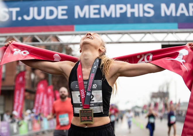 Audrey Davis celebrates finishing the St. Jude Memphis Marathon in less than three hours on Saturday. She was the top female finisher in the race.