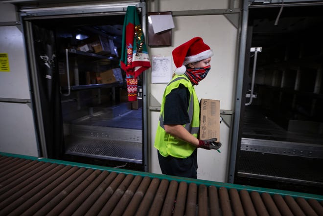 UPS Package handler Amanda Eversole moved boxes to delivery vans at the Louisville hub on Dec. 6, which is considered the peak shipping day of the year.