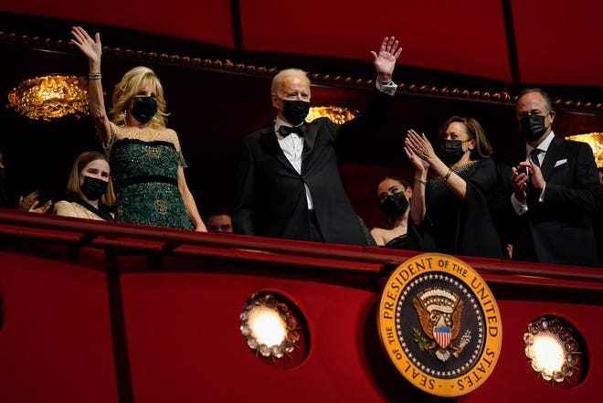 President Joe Biden and first lady Jill Biden wave as they arrive at the 44th Kennedy Center Honors at the John F. Kennedy Center for the Performing Arts in Washington, Sunday, Dec. 5, 2021. Vice President Kamala Harris, and second gentleman Doug Emhoff, applaud at right. The 2021 Kennedy Center honorees include Motown Records creator Berry Gordy, "Saturday Night Live" mastermind Lorne Michaels, actress-singer Bette Midler, opera singer Justino Diaz and folk music legend Joni Mitchell.