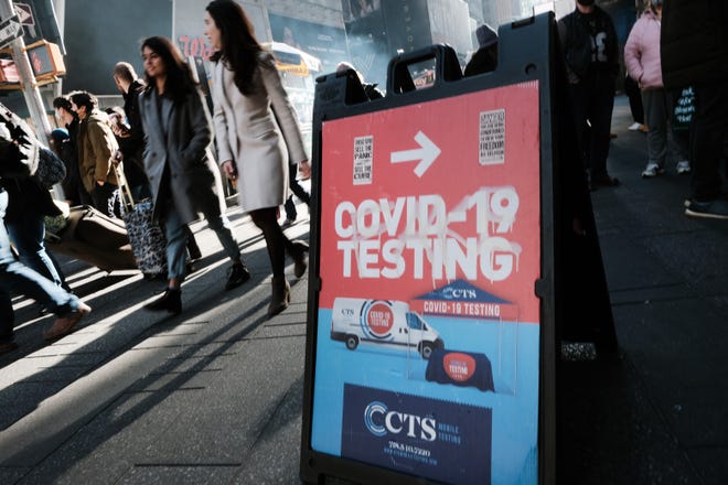 Coronavirus testing is available in Times Square in New York City. After the discovery of the omicron variant, health officials urge people to get vaccine boosters.