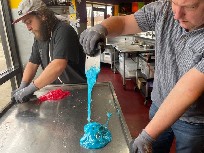 Candy makers Tyler Gilligan, (left) and Keith Karp, owner of Oh My Lolli!, make cotton candy-flavored lollipops at the Brighton shop Tuesday, Dec. 7, 2021.