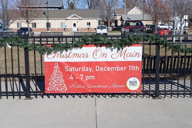 A sign announcing Nevada's first Christmas on Main celebration hangs on the fence at City Hall campus.