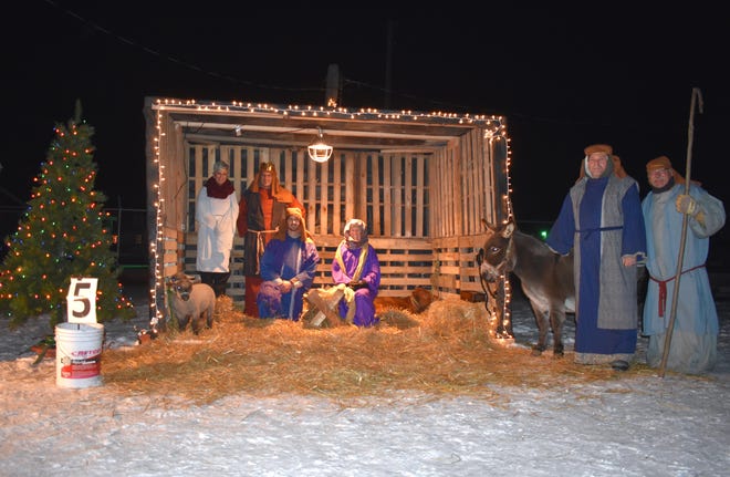 Members of Gateway Community Church pose for a photo during the inaugural "Fair Fantasy Light Drive Thru" at the Lenawee County Fair & Event Grounds in 2020. Church members recreated the Nativity scene and the birth of Jesus Christ. The church was also named the People's Choice Winner for best holiday float/lights display. They will be back again for the second annual Fair Fantasy Lights Drive Thru, taking place Dec. 10 and 11, and Dec. 17 and 18.