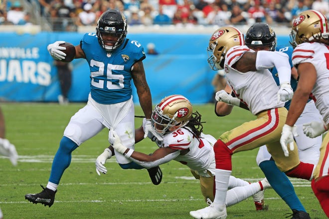 Jaguars running back is wrapped up by James Robinson (25) San Francisco 49ers linebacker Marcell Harris (36) during the second quarter at TIAA Bank Field Sunday, Nov. 21, 2021 in Jacksonville. The Jacksonville Jaguars hosted the San Francisco 49ers during a regular season NFL game. [Corey Perrine/Florida Times-Union]