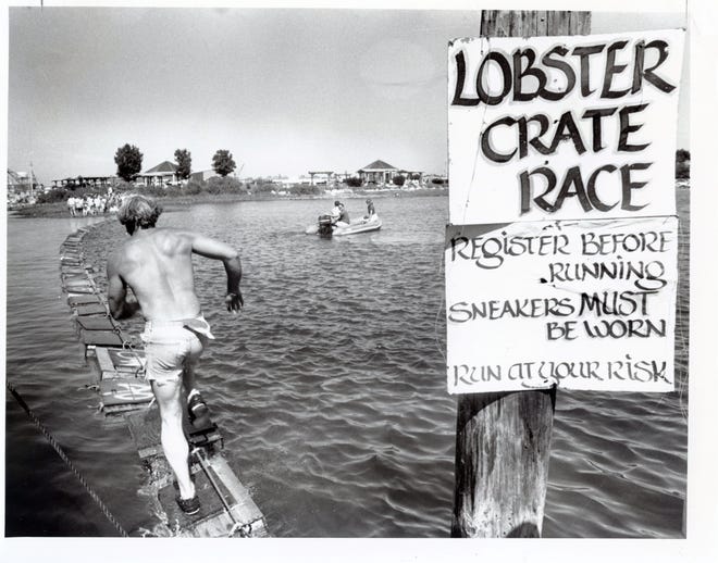 An unidentified young man runs across a string of lobster pots over the water during the Lobster Crate Race, a Market Square Day weekend event that took place between Four Tree Island and the Commercial Fishing Pier on Peirce Island. The image ran in The Portsmouth Press on June 21, 1988.