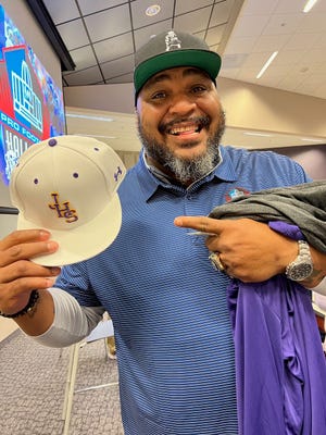 Pro Football Hall of Famer Walter Jones proudly displays a hat he received while speaking to the Jackson football team on Wednesday.