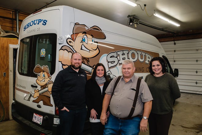 Doug Shoup, left, Kristen Shoup, Doyle Shoup, and Tiffany Poland pose for a portrait in front of the newest cleaning van operated by Shoup's Cleaning Company.