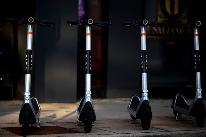 Bird scooters are stood up awaiting use in Over-The-Rhine on Wednesday, Dec. 8, 2021. 