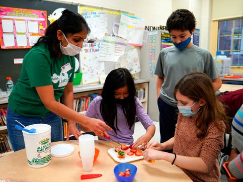 Maugham School students make yogurt parfaits in a lesson in nutrition during an after school program with the Health Barn's Pooja Patel, far left, on Thursday, Dec. 2, 2021, in Tenafly.