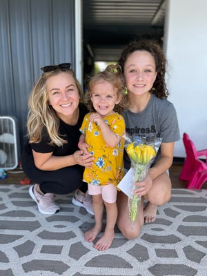 Kelly Brennan (left), her daughter Caroline and niece Elleigh Culver pose for a photo the day of the release of "Caroline's Infusion Day." Brennan wrote the book accompanied by Elleigh's illustrations.