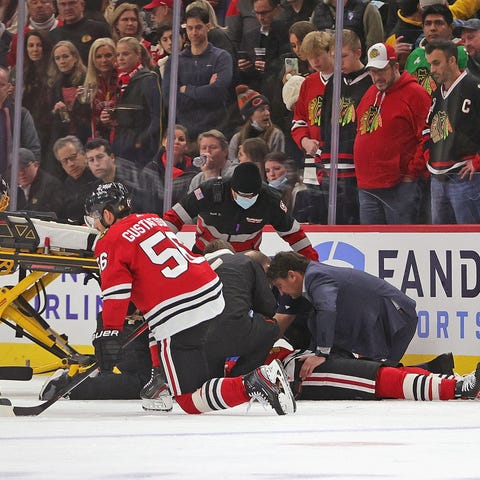 Jujhar Khaira of the Chicago Blackhawks is tended 