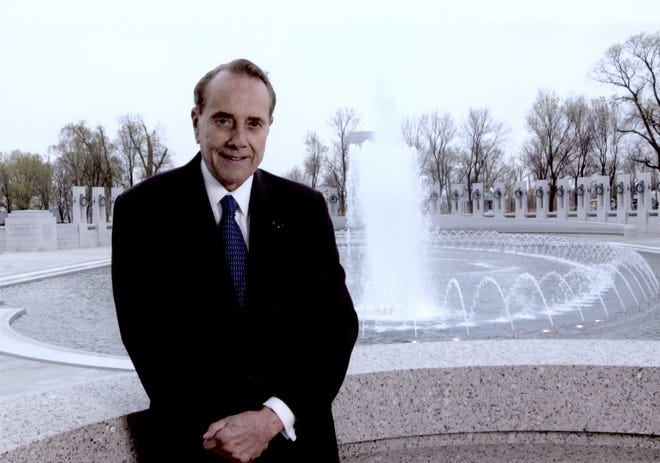 Bob Dole is pictured here in at the WWII Memorial. He is remembered as a hero and statesman, a journey that started in nearby Russell.