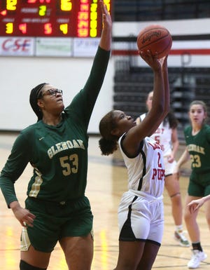 Paris Stokes (right) of McKinley takes a shot while being defended by Jordan Weir (left) of GlenOak during their game at McKinley on Wednesday.