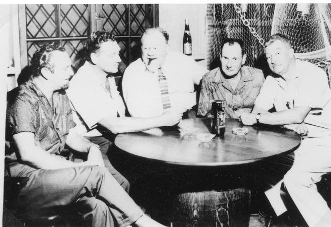 From right to left, MacKinlay Kantor, Richard Glendenning and Burl Ives share a drink with two other unidentified individuals.