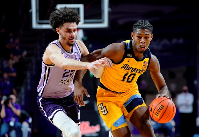 Marquette forward Justin Lewis (10) drives against Kansas State's Ismael Massoud (25) during the first half  Wednesday night at Bramlage Coliseum.