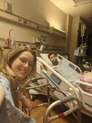 From left, Katrina Smith snaps a photo of herself and Ryne Smith during their recoveries after surgery. Both University of Alabama law school students decided to become kidney donors. [Photo by Katrina Smith]