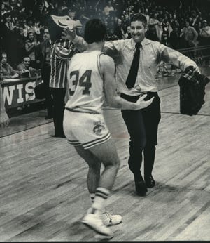 Coach John Powless of Wisconsin was ready to hug guard Bob Falk after Wisconsin beat Ohio State in overtime in 1976, 82-81.