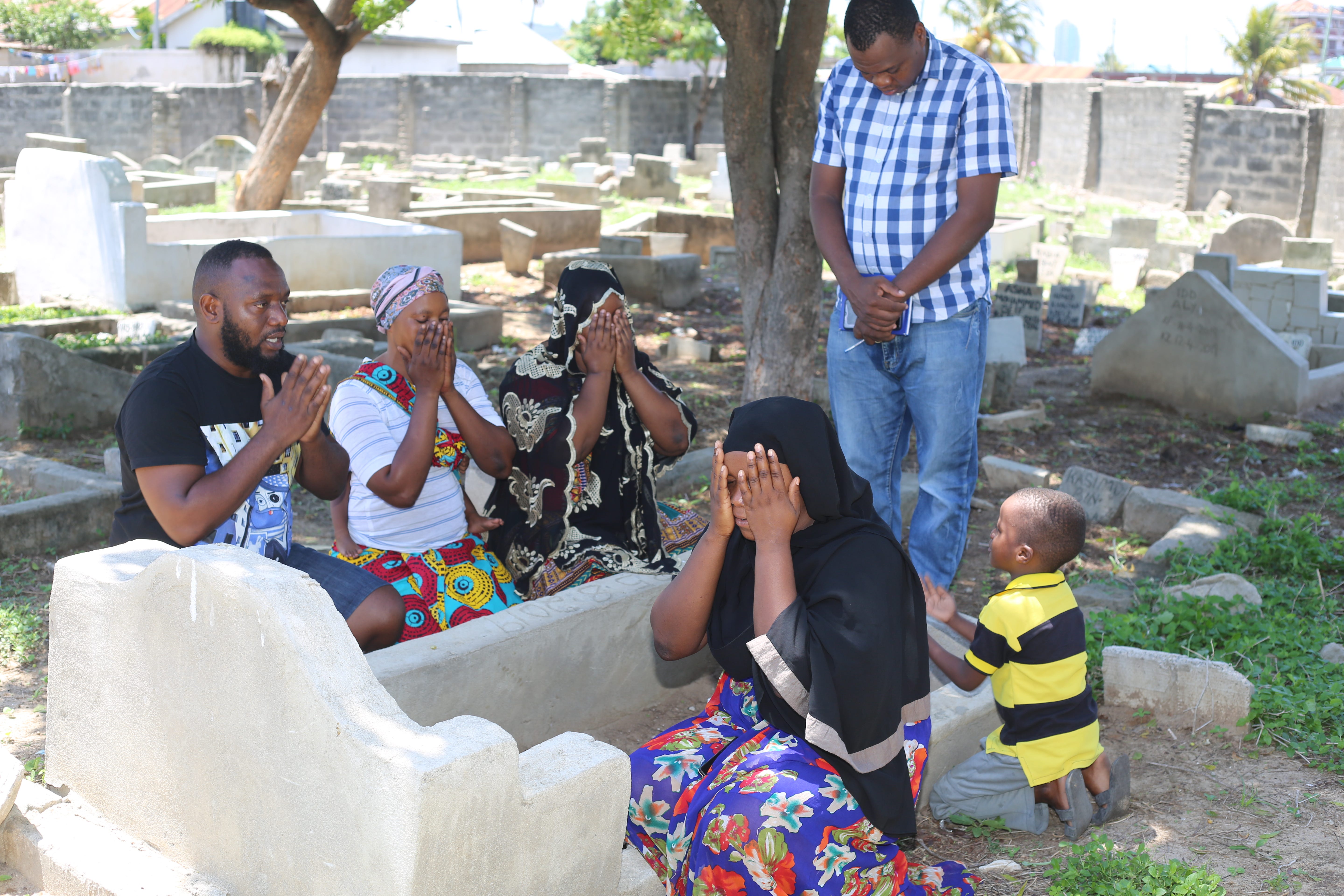 Family members of late Rabia Issa and a freelance Tanzanian reporter pray at the grave of the late Rabia at Msasani graveyard in Dar es Salaam Tanzania.