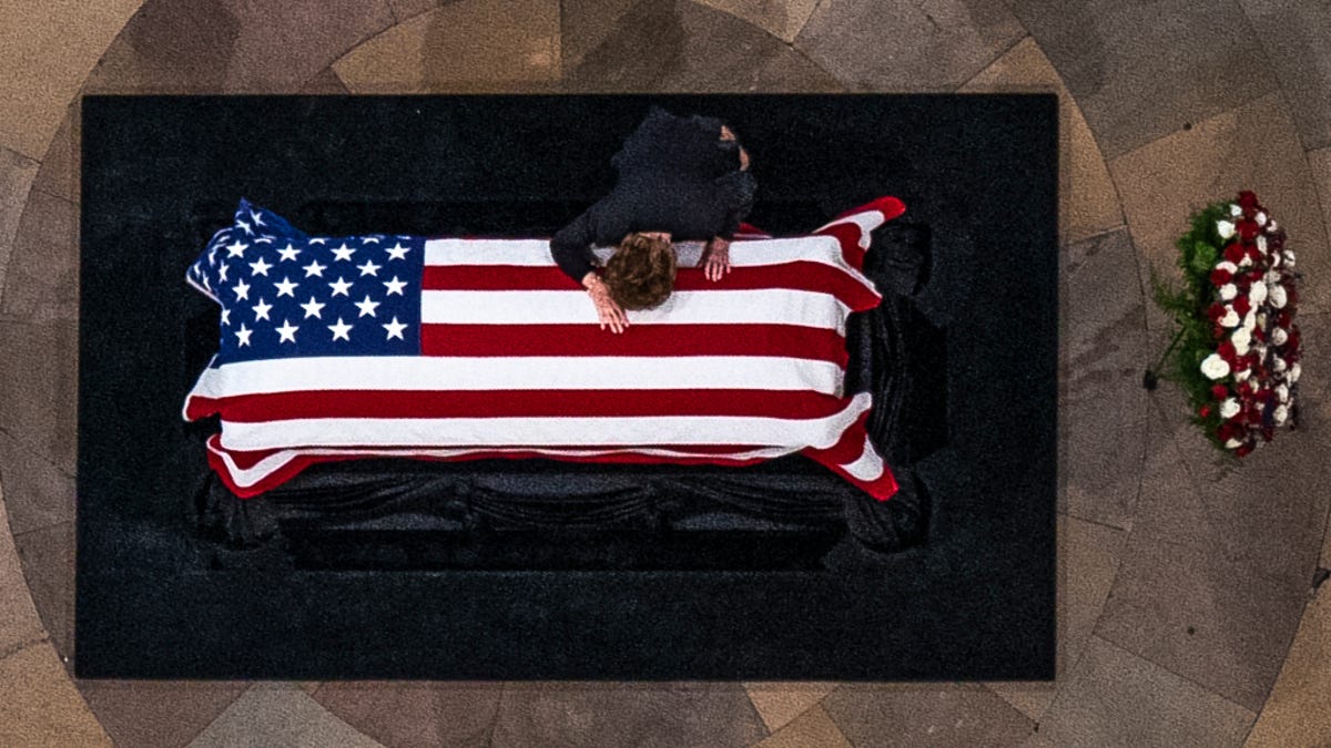 Elizabeth Dole cries on casket of her husband, former Sen. Bob Dole, R-Kan., as he lies in state in the Rotunda of the U.S. Capitol, Thursday, Dec. 9, 2021, on Capitol Hill in Washington.