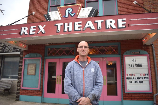 Morenci resident Tim Newsom stands in front of the Rex Theatre in downtown Morenci Thursday afternoon. Newsom has owned the theater for more than a year and a half. He has been rehabilitating the once-empty structure and will offer a screening of the Christmas movie "Elf" at 6:30 p.m. today and Sunday, Dec. 11 and 12.