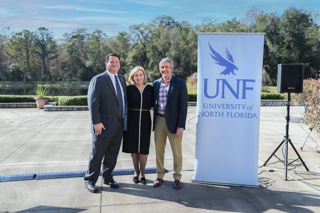 Jason Burnett, Pamela Chally and Chip Skinner pose for a photo at Hicks Hall on the University of North Florida's campus after announcing the 190-acre gift to the institution.