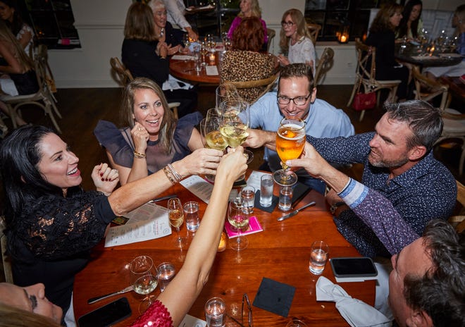 Fest-goers toast at the "First Bite" dinner at Buccan Palm Beach Dec. 9 during the 2021 Palm Beach Food and Wine Festival 2021.