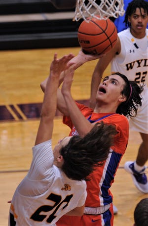 Canutillo's Gio Gutierrez shoots over Wylie's Isaiah Carrillo (20) for the game-tying basket with 4.4 seconds left in regulation. It sent the game into overtime tied at 57, and the Eagles beat Wylie 70-64 on the opening day of the Catclaw Classic on Thursday at Wylie's Bulldog Gym.