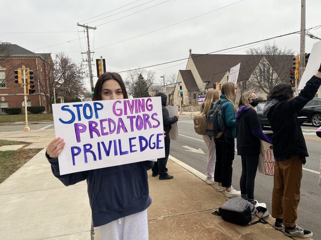 Sophia Sauseda, a senior at Wauwatosa East High School, holds a sign during a walkout Friday. The walkout was to protest how claims of sexual assault and harassment are being handled by the school administration and the district.
