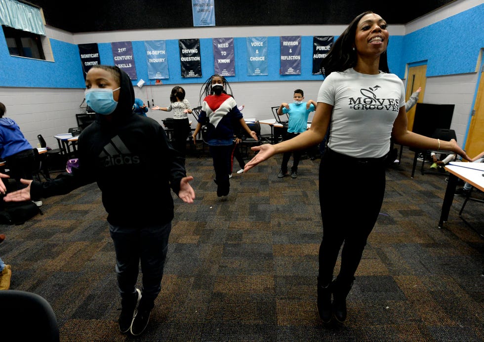 Dr. Emerald Mitchell dances with students at JFK Middle School on Wednesday, December 7, 2021 in Antioch, Tenn. Mitchell started the children's arts program Moves and Groves when she was a Fisk University student.