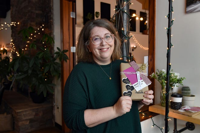 Stephanie Logue poses for a portrait with one of the "date with a book" options available on her Etsy page on Friday, December 10, 2021, in Sioux Falls.